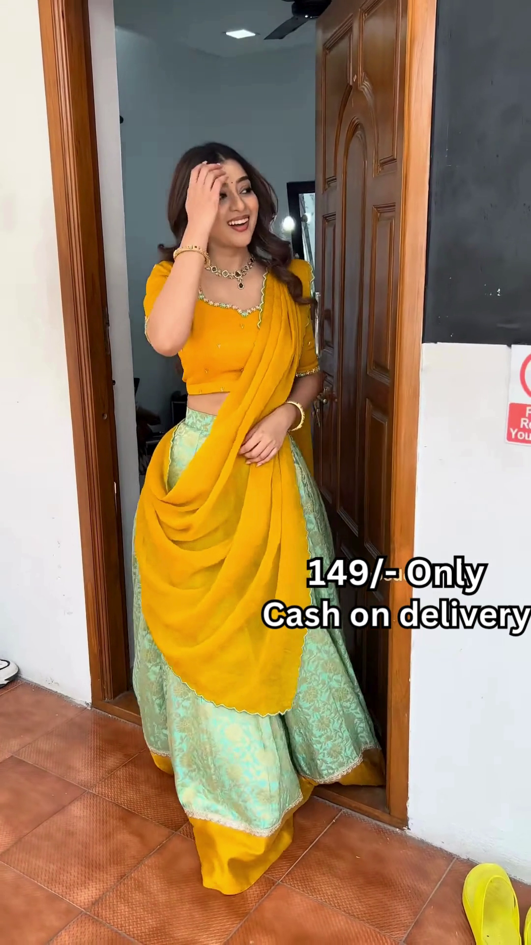 Women’s Red Embroidered Skirt Top Set with Traditional Earrings – Ethnic Doorway Portrait Ensemble - Image 5