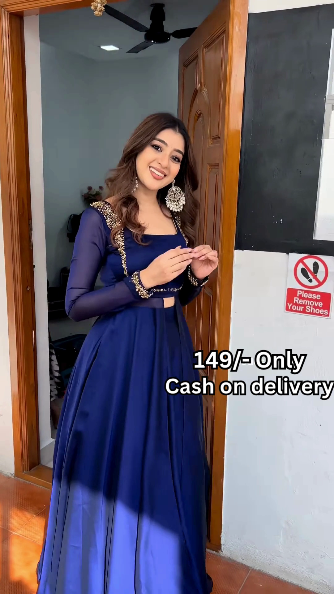 Women’s Red Embroidered Skirt Top Set with Traditional Earrings – Ethnic Doorway Portrait Ensemble - Image 4