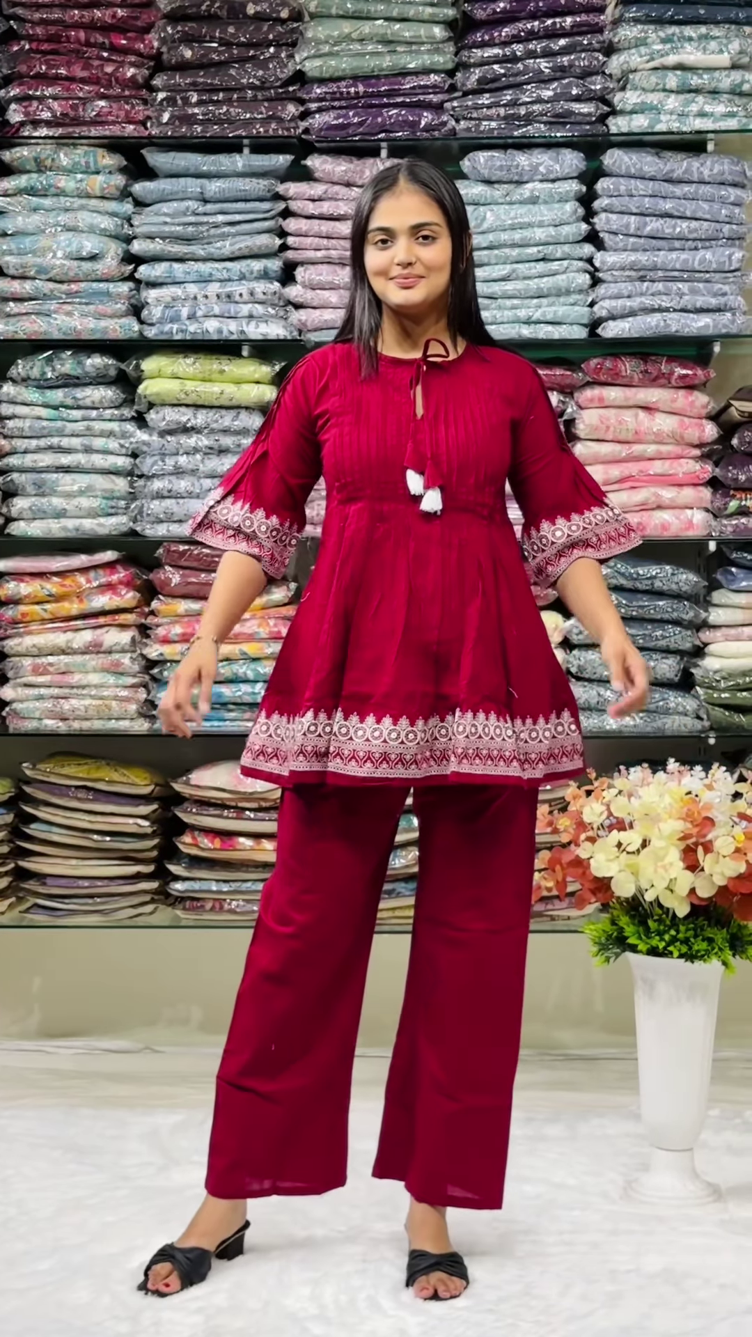 Women’s Red Embroidered Kurti Pant Set – White Threadwork Details with Boutique Shelf Backdrop - Image 3