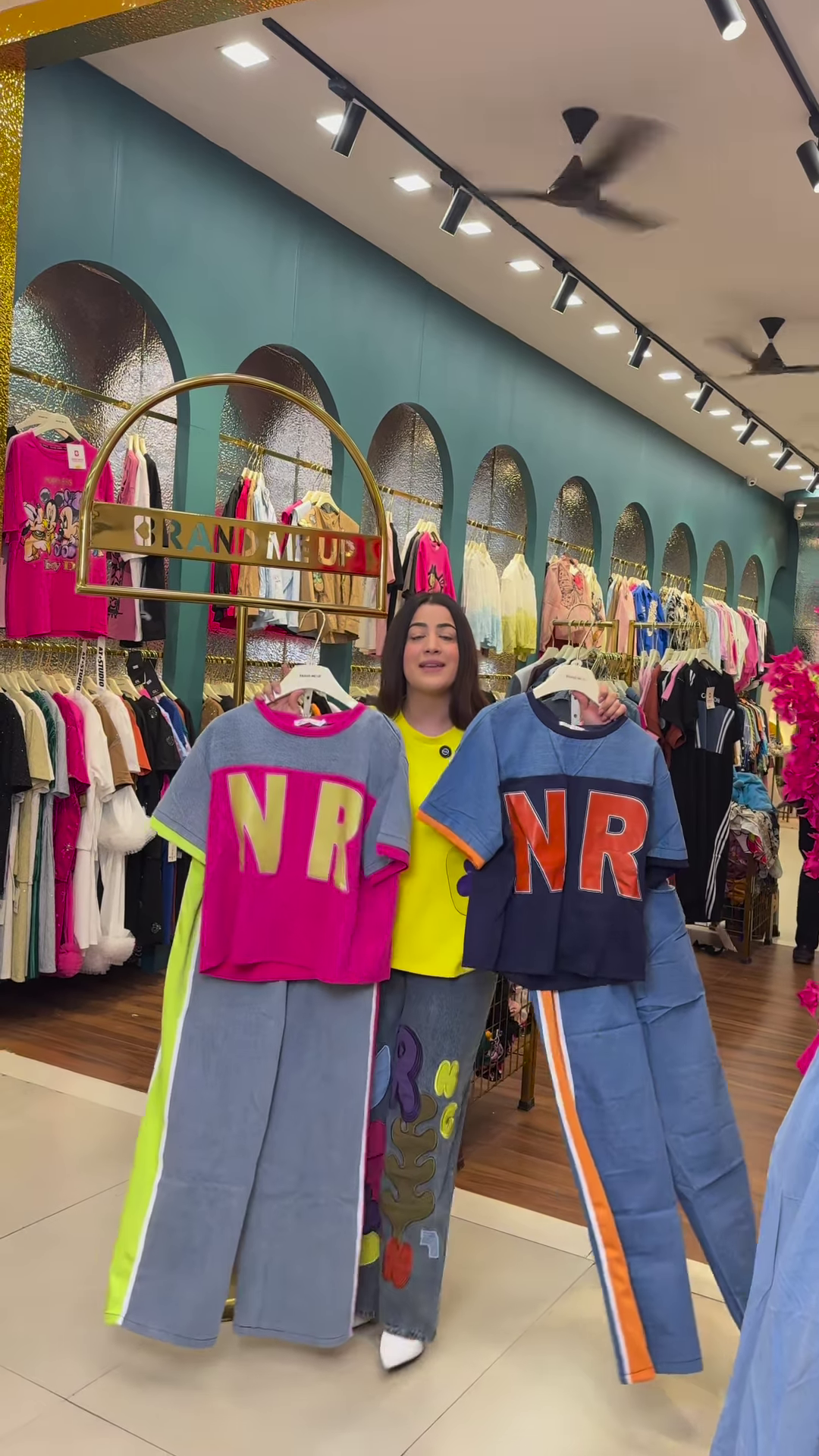 Multicolor Printed Ethnicwear Rack Display – Bold Floral & Abstract Garments in Boutique Interior with Teal-Gold Accents - Image 2