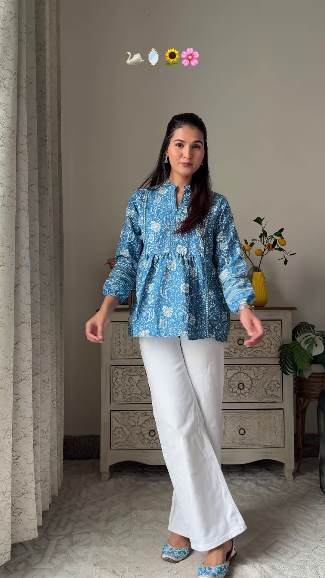 Women’s Sleeveless Red Floral Top with Light Blue Flared Jeans – Indo-Western Casualwear Styled with Vintage Decor Backdrop - Image 2